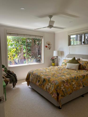 a bedroom with a bed and a large window at Bexhill Grace in Lismore