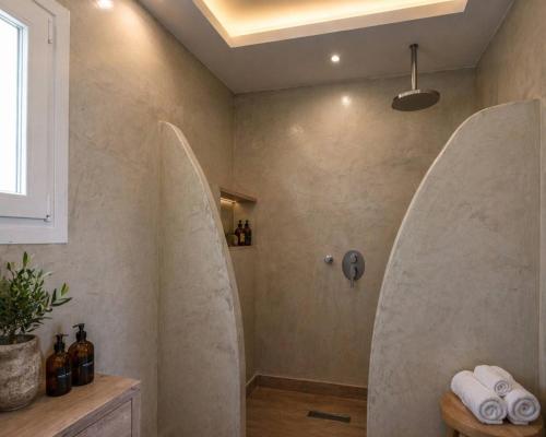a bathroom with surfboards on the wall at Studio in a family hotel in Perivolos