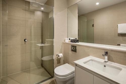 a bathroom with a toilet and a sink and a shower at Quest Dandenong Central in Dandenong