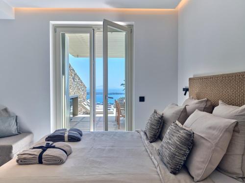 a bedroom with a bed with a view of the ocean at Eos Villa in Drios