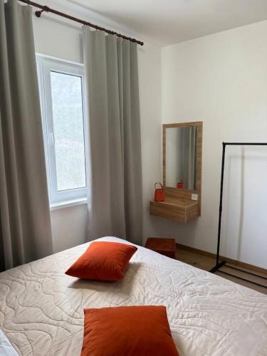 a bedroom with a bed with two red pillows on it at Balcony in Shatin