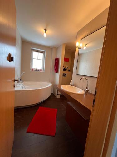 a bathroom with a large tub and a sink at Ostseebauernhof Schönhagen in Brodersby