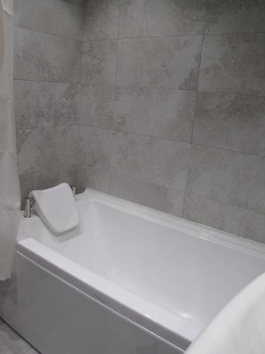 a white bath tub with a toilet in a bathroom at Inna`s Studio in Tbilisi City