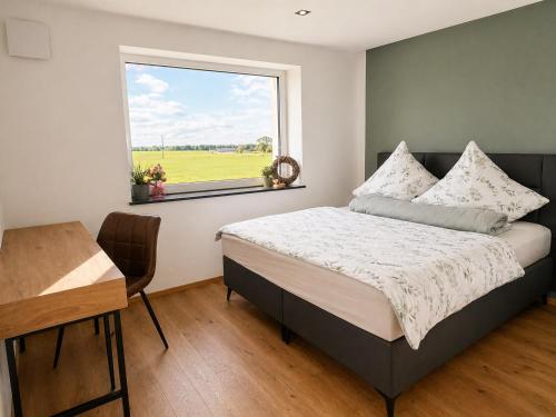 a bedroom with a bed and a window and a desk at Apartment Ihm in Memmingen