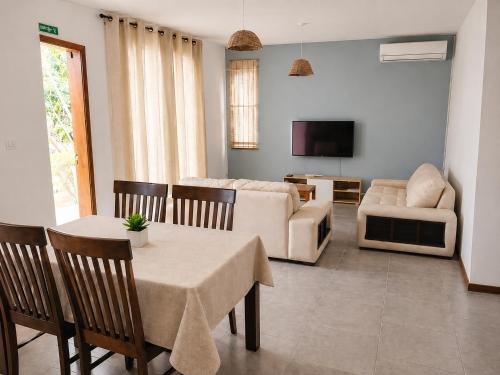 a living room with a couch and a table and chairs at La Maison d'Isa in Albion