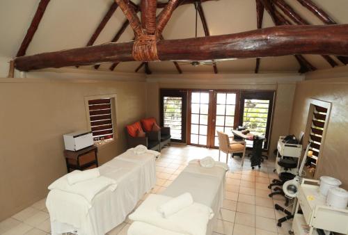 a living room with white chairs and a table at Erakor Island Resort & Spa in Port Vila