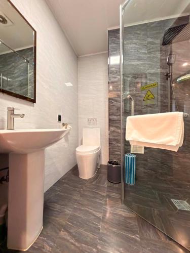 a bathroom with a sink and a shower and a toilet at TTI Hotel in Ulaanbaatar in Ulaanbaatar