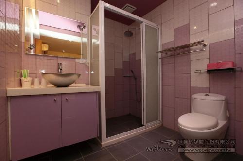 a bathroom with a toilet and a sink and a shower at Macaron B&B in Luodong