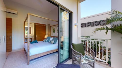 a bedroom with a bed on a balcony at Ki Residences Apartments & Penthouse by LOV Mauritius, Pereybere in Pereybere