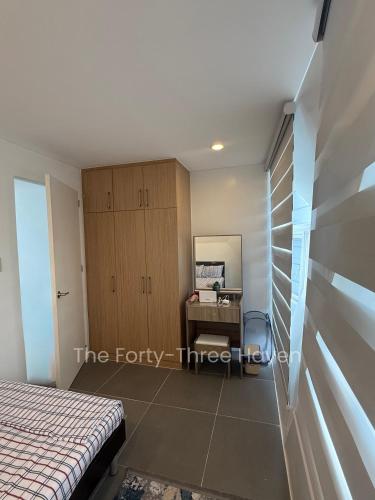 a bedroom with a bed and a desk at The Forty-Three Haven in Calo