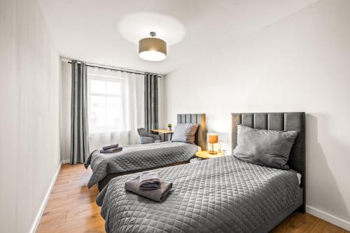 a bedroom with two beds and a window at Platinum Elite Residence in Rybnik