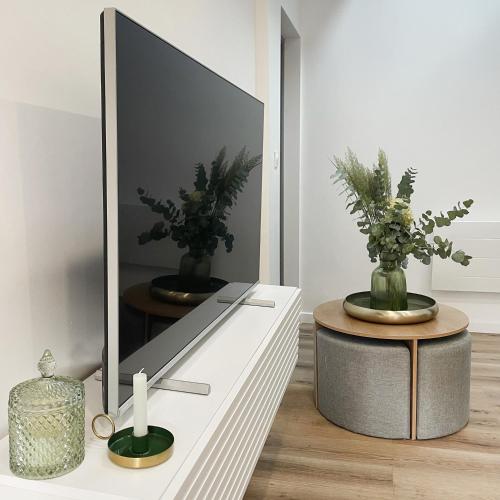 a living room with a tv on a dresser at Suite des Princes with Private Garden by La Boîte En Plus in Chantilly