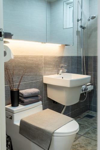 a bathroom with a white toilet and a sink at 스테이 한집 in Suwon