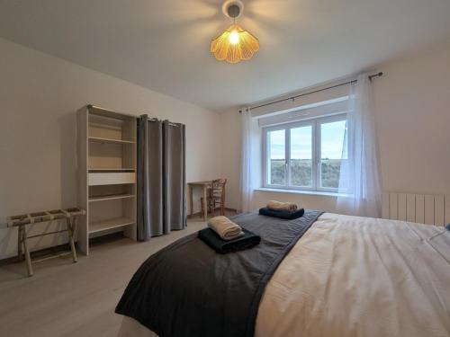 a bedroom with a bed with two towels on it at Gîte du joliment in Consigny