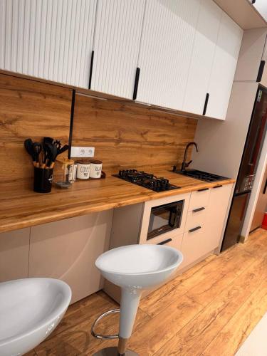 a kitchen with a white sink and a stove at Apartment prime residence in Ak-Tyube