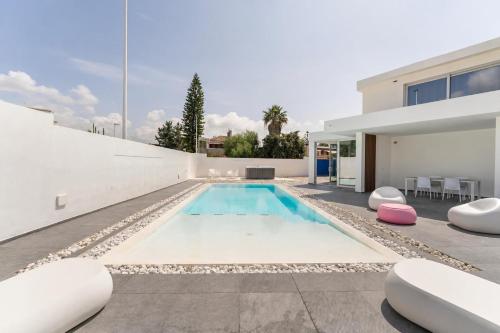 a swimming pool in the backyard of a house at Leonida's Home - Shared Pool, Jacuzzi and beach 150mt in Su Forti