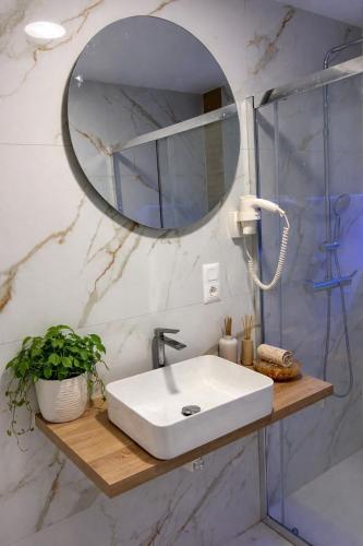 a bathroom with a white sink and a mirror at Las Americas Prime Suite Spot in Costa de Adeje