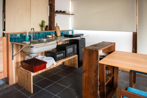 a kitchen with a sink and a counter at Nuu Takedamise, the Villa in Kami-yuge