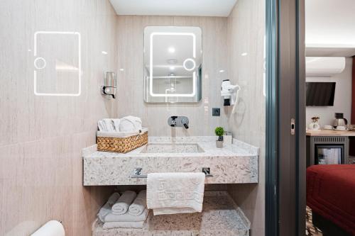 a bathroom with a sink and a mirror at Taksim Artelist Hotel in Istanbul