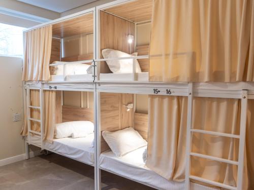 a room with two bunk beds with white pillows at Fresh hostel in Almaty