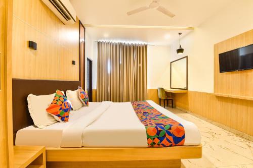 a hotel room with a bed and a television at FabHotel Madhuban in Jaipur