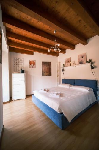 a bedroom with a large bed and wooden ceilings at Casa Valerija in Aurisina