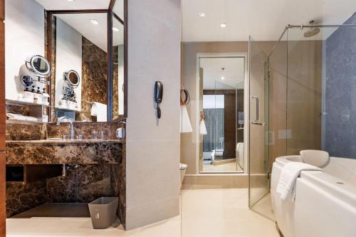 a bathroom with a toilet and a sink and a shower at S31 Sukhumvit Hotel in Bangkok