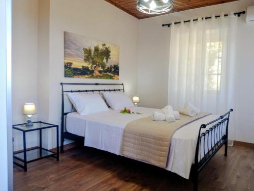 a bedroom with a large bed and a window at Villa Makris in Zenempisátika