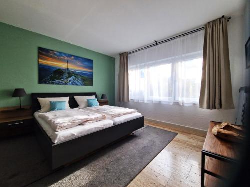 a bedroom with a bed and a large window at Ferienwohnung Zürcher in Chieming