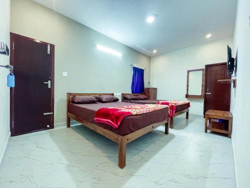 a bedroom with two beds in a room at The Storyhouse in Kūkkāl