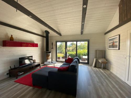 a living room with a couch and a tv at kirsikkaranta 1 in Pargas
