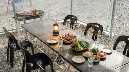 a table with a plate of food on top at Daebudo Banditbul Pension in Ansan