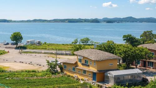 an aerial view of a house next to the water at Daebudo Banditbul Pension in Ansan