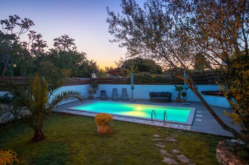 a swimming pool in the backyard of a house at Stonehouse Ewa&Pool in Medulin