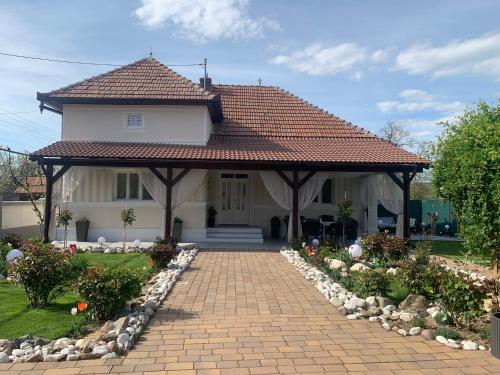 a house with a brick walkway in front of it at CASA LUI MOȘU in Alba Iulia
