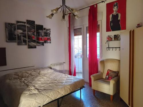 a bedroom with a bed and a chair at Casa Muscas in Iglesias
