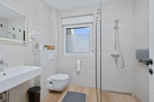 a bathroom with a shower and a toilet and a sink at House AGAPE near Zagreb with rooftop jacuzzi in Kerestinec