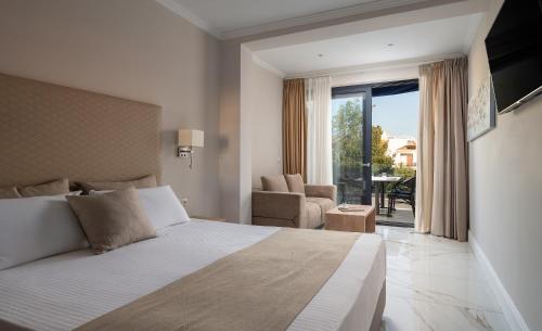 a bedroom with a bed and a view of a patio at La Mer Escape in Nikiti