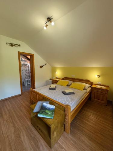 a bedroom with a large bed with yellow pillows at Turistična kmetija Čerček in Solčava