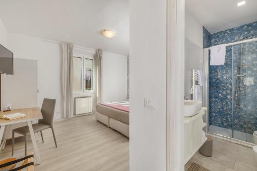 a room with a bed and a sink and a desk at B&B Il Connubio - Rooms & Apt between Florence and Chianti in Impruneta