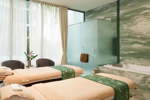 a hospital room with three beds and a tub at GreenLa by Villacarte in Layan Beach
