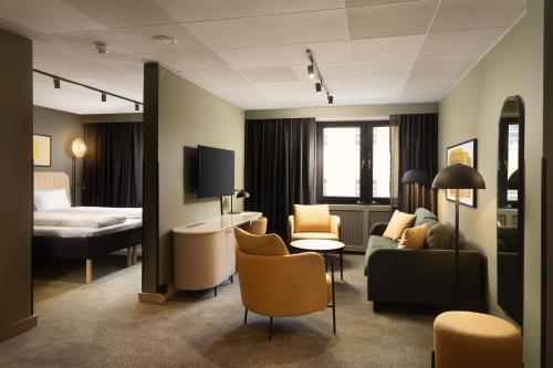 a hotel room with a bed and a living room at Scandic Neptun in Bergen
