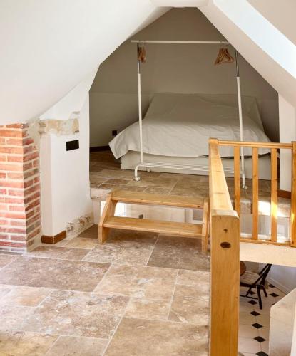 a bedroom with a bunk bed in the attic at Le Grand Clos Marçon in Marçon