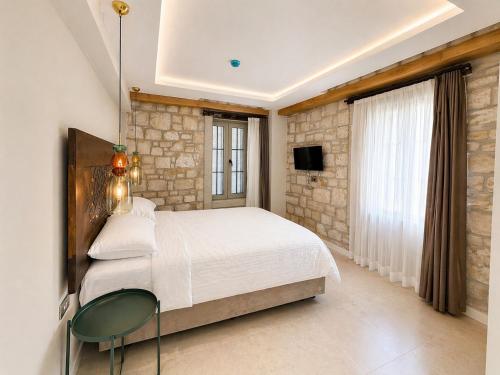 a bedroom with a bed and a table and a tv at Studio Miscela in Urla