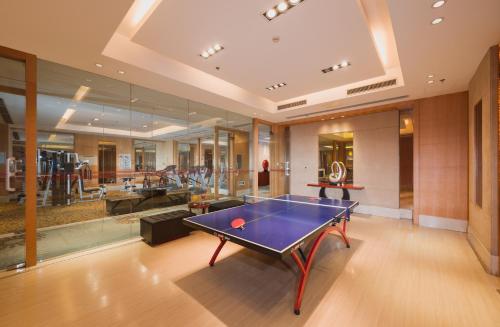 a living room with a ping pong table at Shu Guang International Hotel in Nanjing