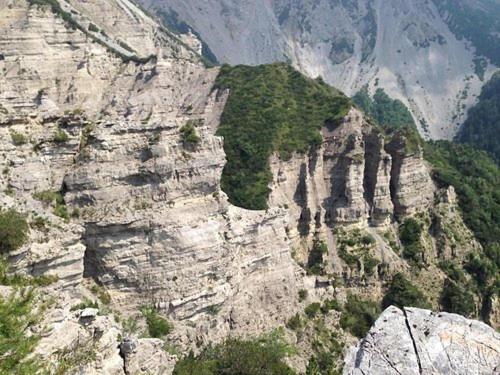 a view of a rocky mountain with trees on it at salvia in Arta Terme