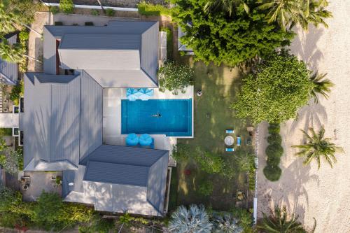 an overhead view of a house with a swimming pool at Ban Laem Set - by Sublime Samui Villas in Laem Set Beach