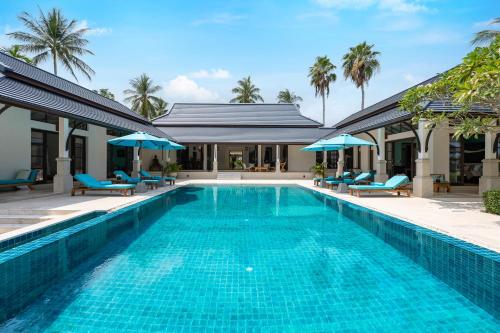 a swimming pool in front of a villa at Ban Laem Set - by Sublime Samui Villas in Laem Set Beach