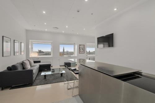 a white living room with a couch and a table at Danhostel Copenhagen City & Apartments in Copenhagen