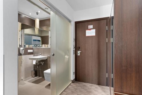 a bathroom with a toilet and a sink at Park Hotel Diament Zabrze - Gliwice in Zabrze